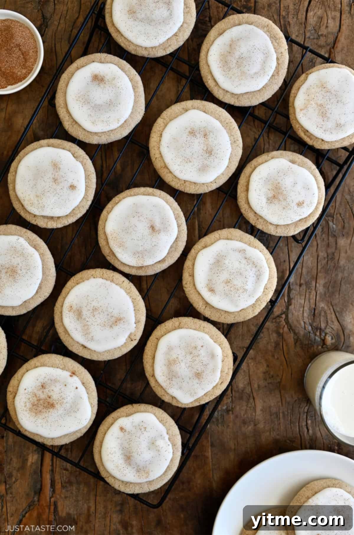 Iced chai sugar cookies with cinnamon cooling on a rack.