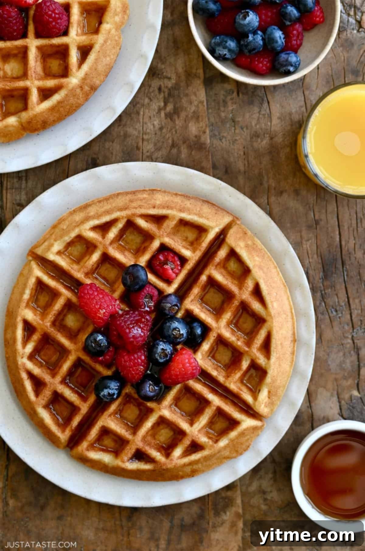 Crisp, golden brown protein waffle topped with maple syrup and fresh berries