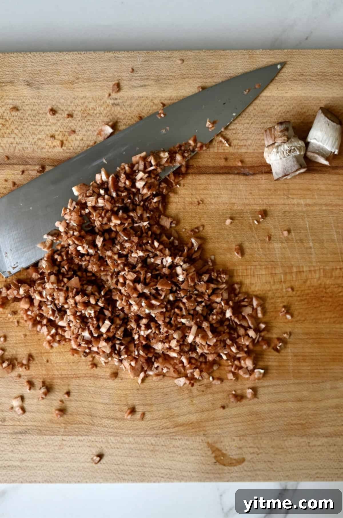 Sausage-Kissed Mushroom Bites 6 Chopping the mushroom stems