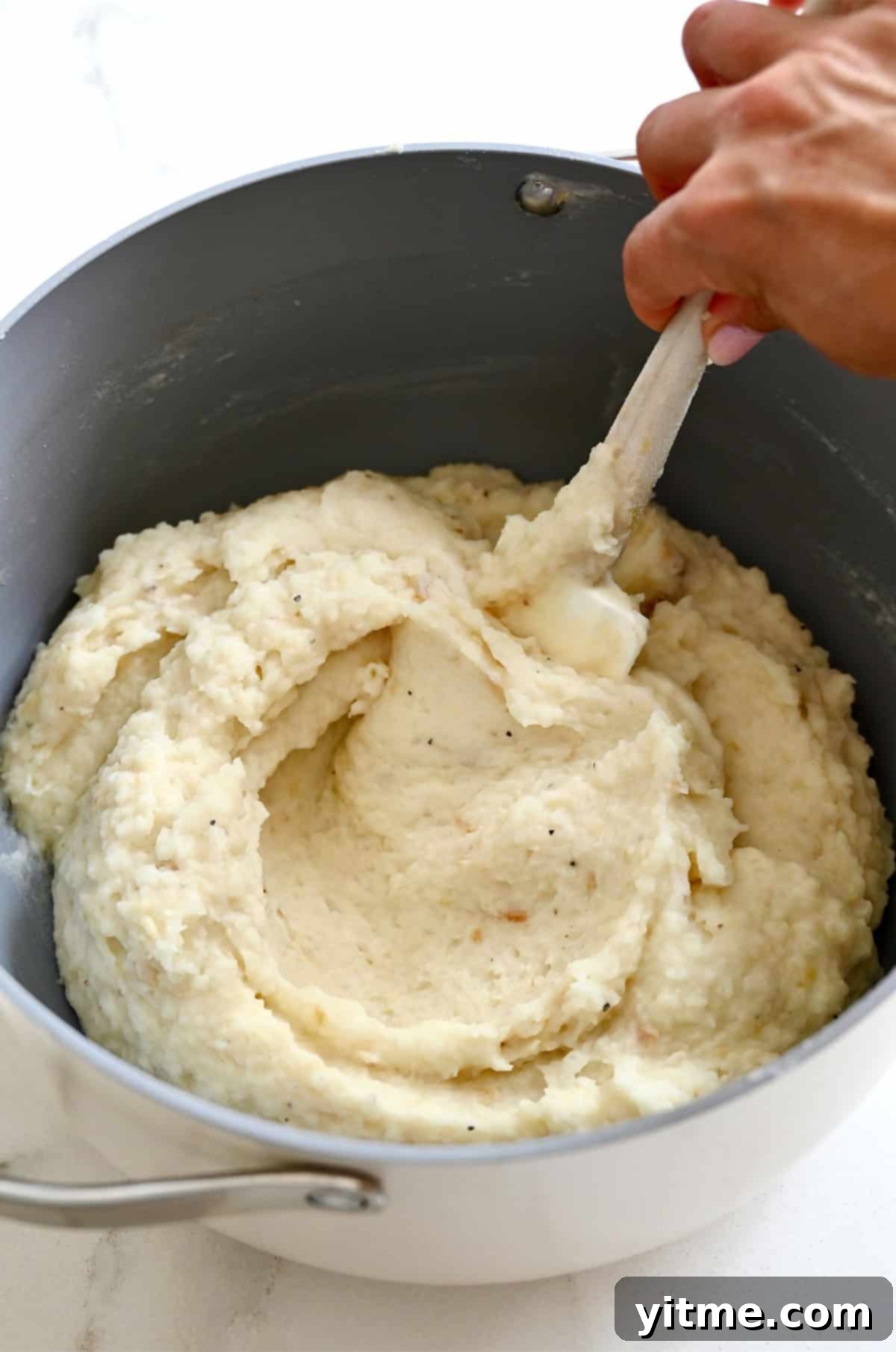 Creamy roasted garlic mashed potatoes in a pot, ready to serve.