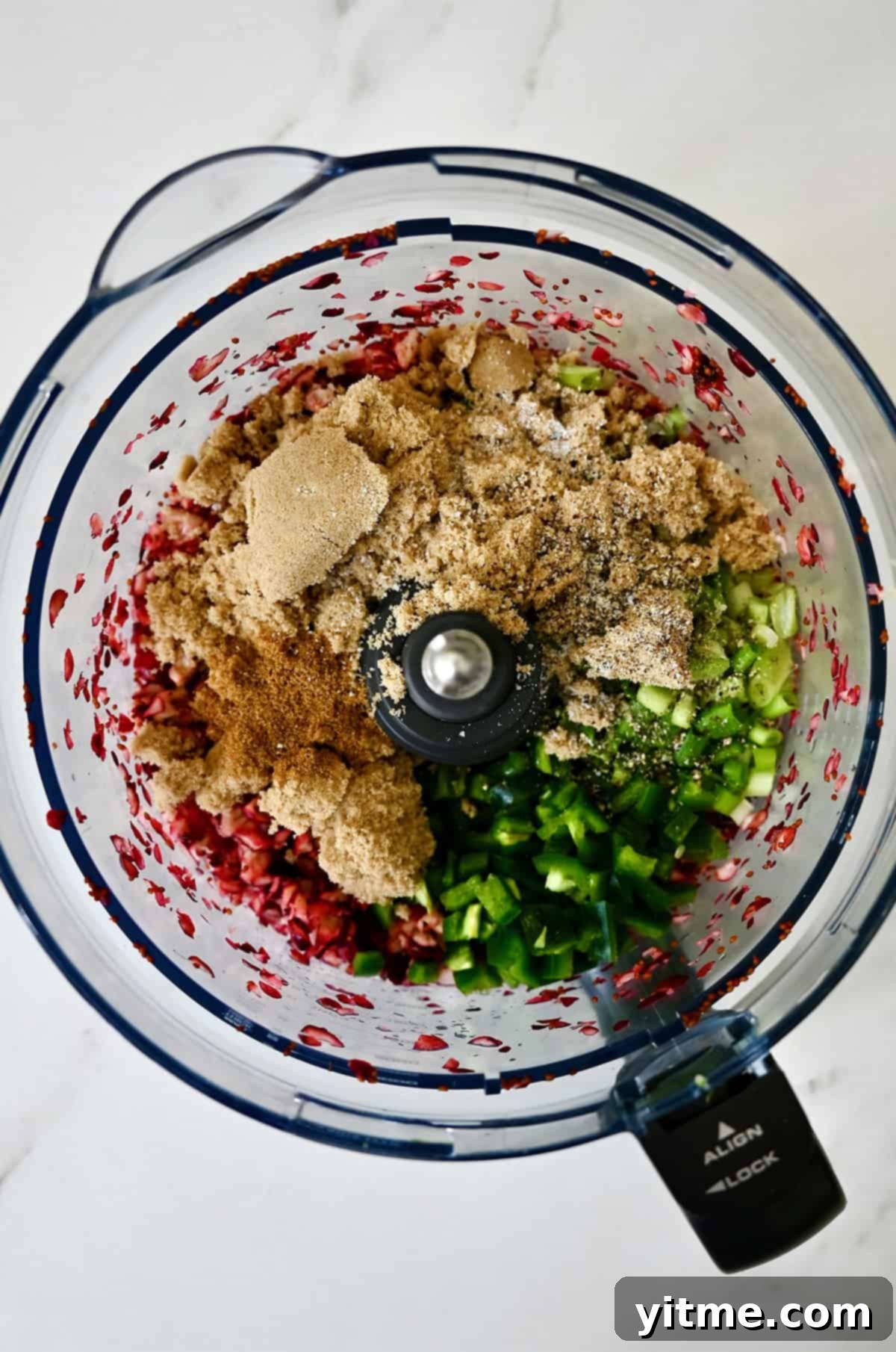 Brown sugar, chopped jalapeño, cumin, lime juice, lime zest and chopped scallions in a food processor with chopped cranberries, all the ingredients needed for the spicy and sweet topping.