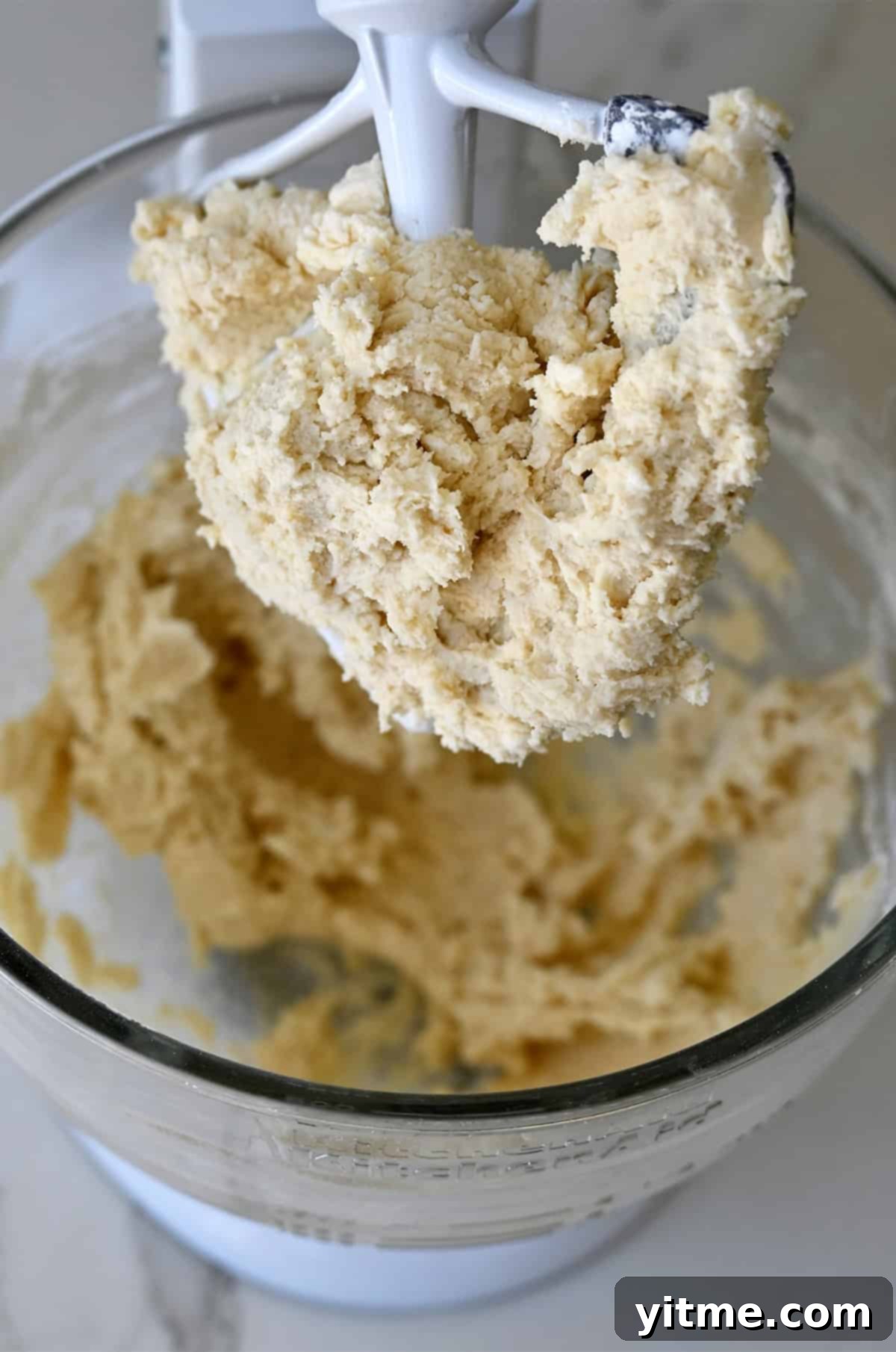 Spritz cookie dough in a stand mixer.