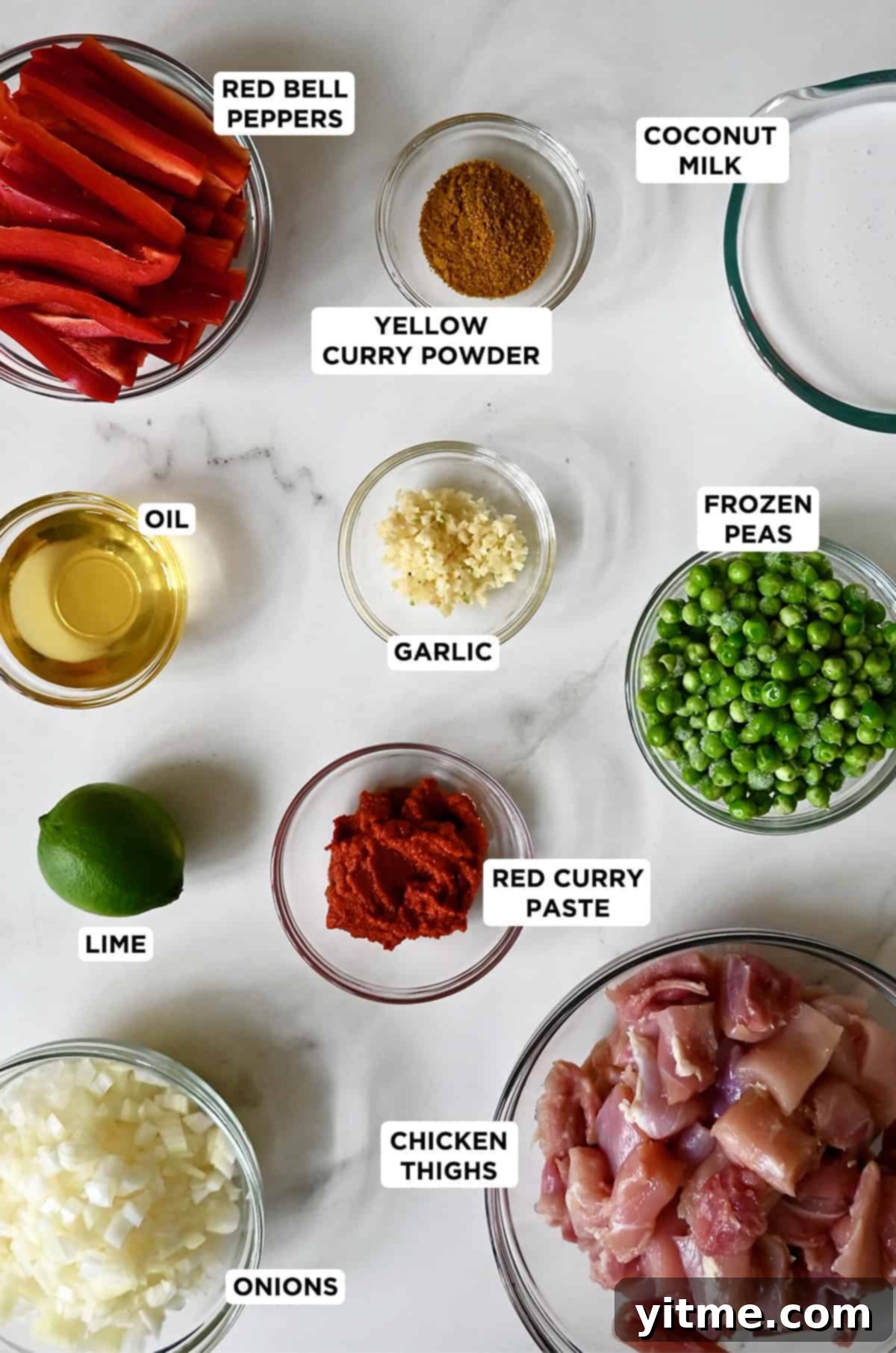 Coconut chicken curry ingredients in various sizes of glass bowls.