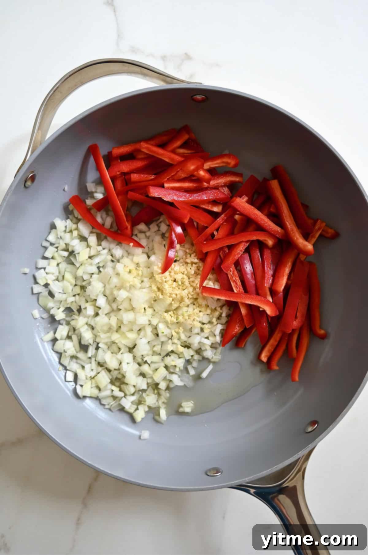 Diced onions, minced garlic and sliced red bell pepper in a large skillet with olive oil.
