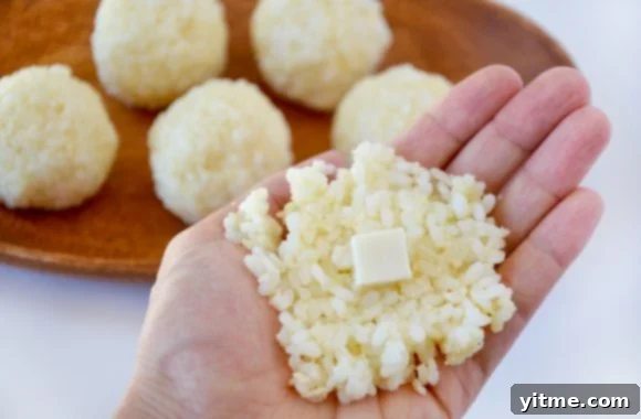 Hand forming arancini ball with rice and mozzarella cheese