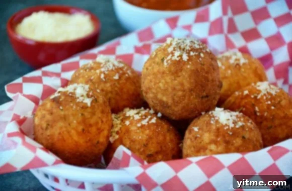 Easy arancini in basket topped with parmesan cheese