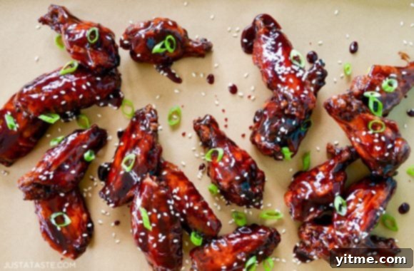 Delicious baked asian chicken wings garnished with sesame seeds and scallions