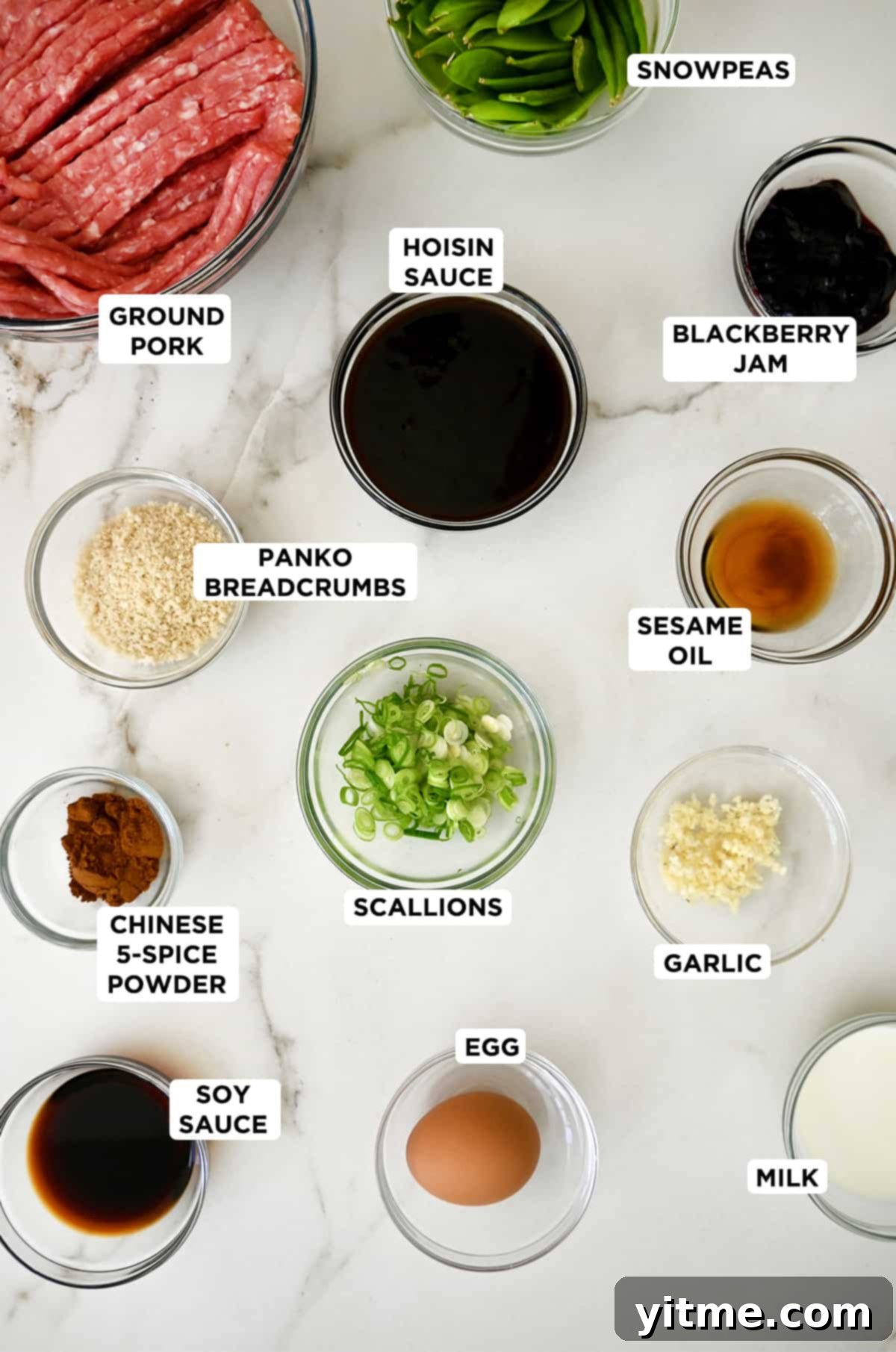 Ingredients for blackberry jam meatballs including hoisin sauce, ground pork, scallions, blackberry jam, sesame oil, garlic, egg, panko breadcrumbs, Chinese 5-spice powder, and soy sauce.